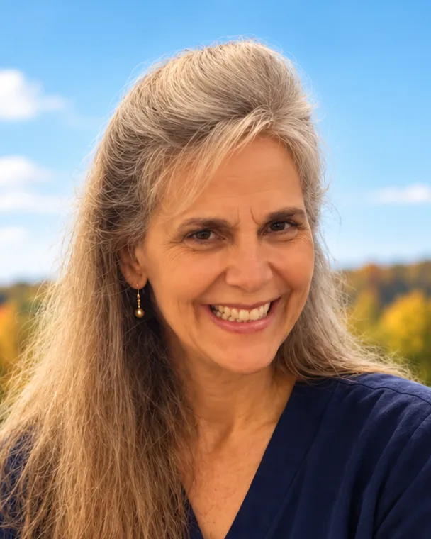 Marianne Cano, founder of Merciful Love Ministries and Catholic pastoral counselor, smiling outdoors in autumn