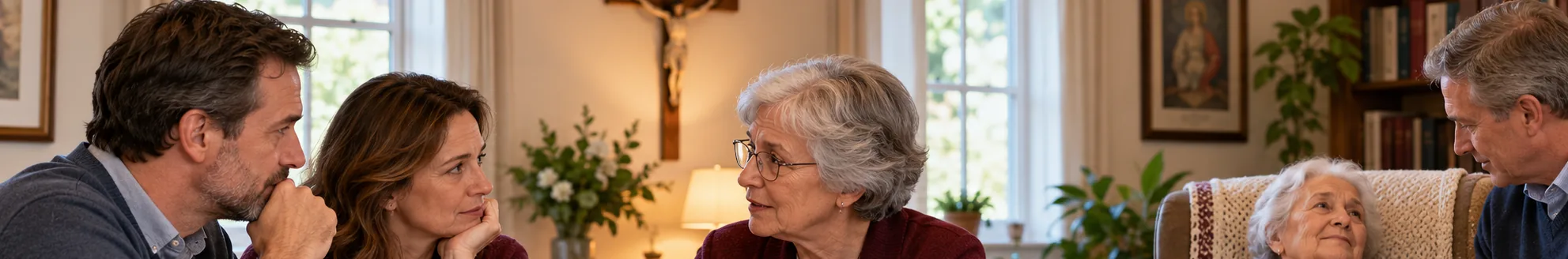 A family and an older woman in conversation around a table in a warm home, with a crucifix on the wall